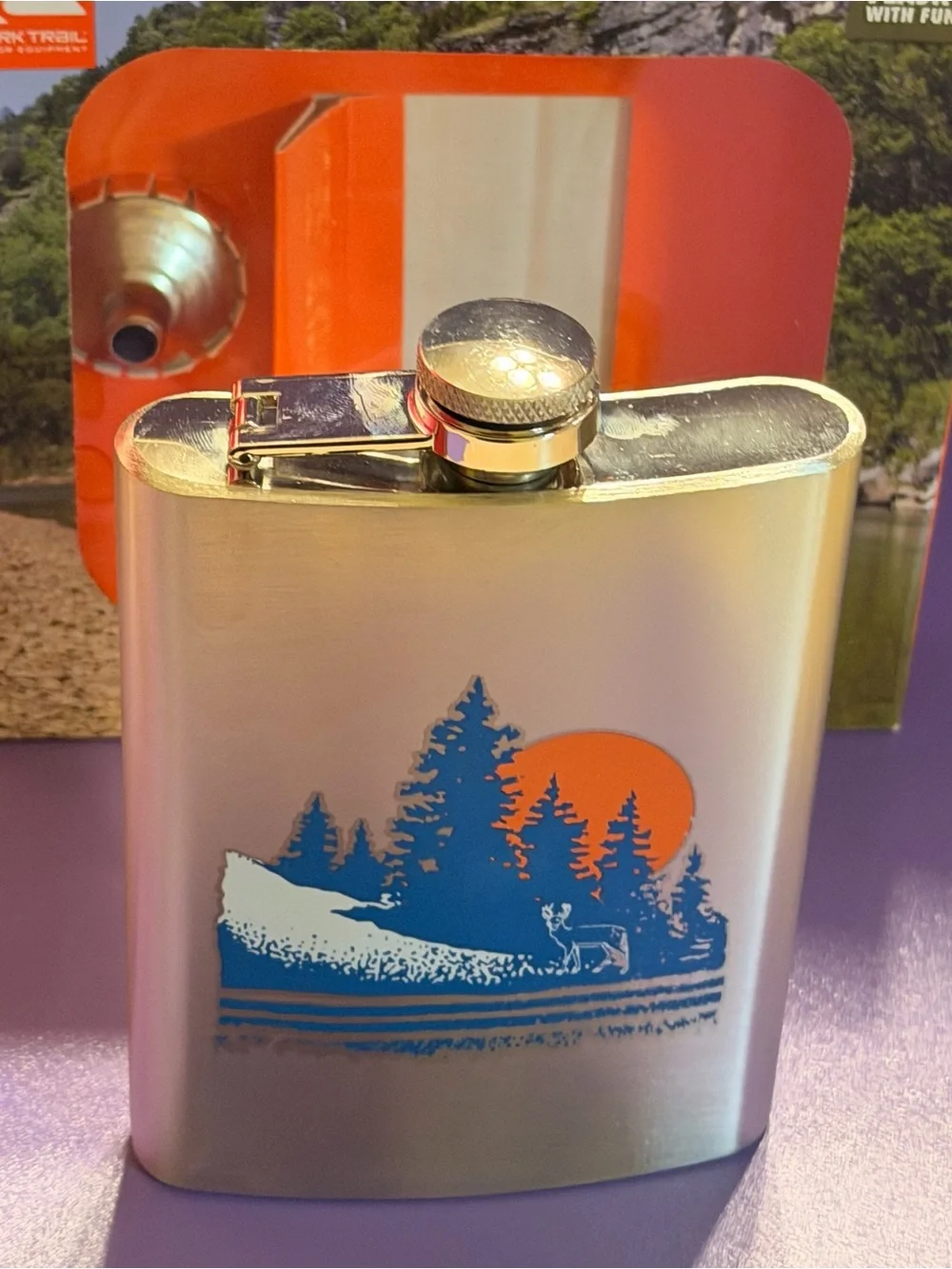 Ozark Trail Silver Hip Flask with Blue Forest and Orange Sun Design